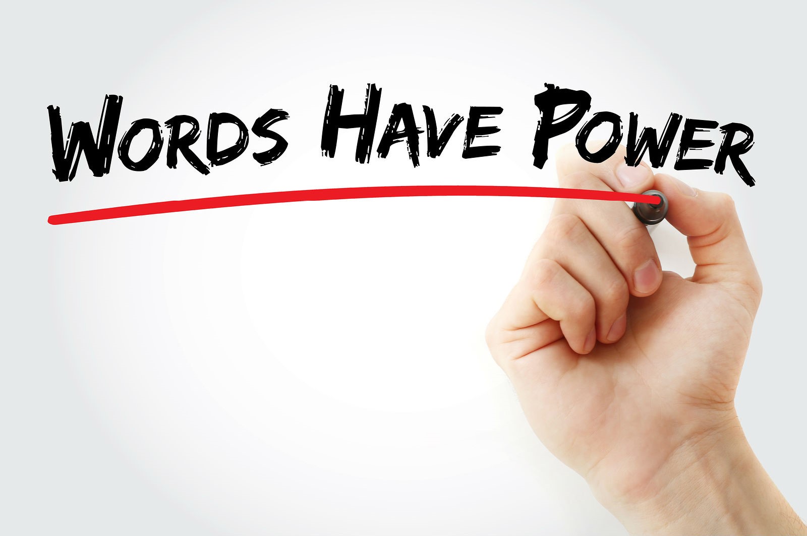 A hand writing "Words have power," underlined in red.